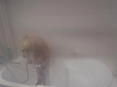 Teen in the bathtub relishing a long steam shower